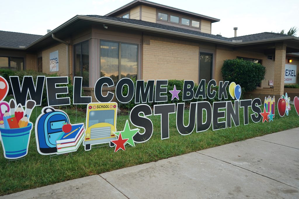 welcome back students sign in front of school