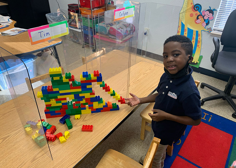 student building lego wall